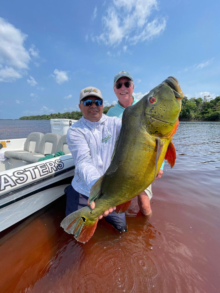 a-fisherman-reeling-in-a-peacock-bass---viet-nam-fishing-tous-trips