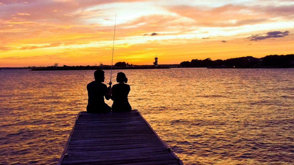 The romantic sunset moment makes the fishing trip even more enjoyable.