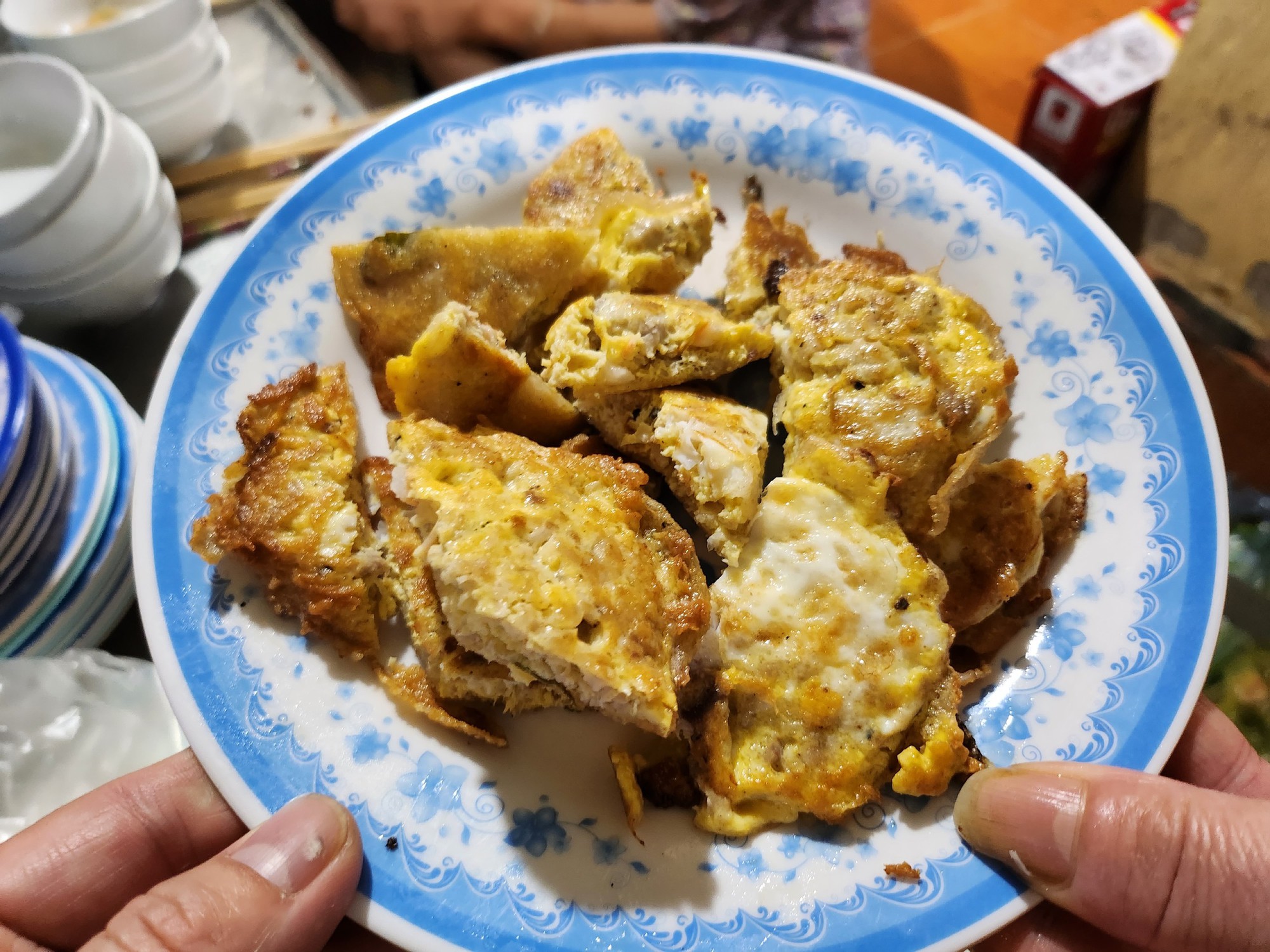 Bánh Khoái Nồi Rang (a savory, crispy crepe packed with fresh seafood and local herbs)