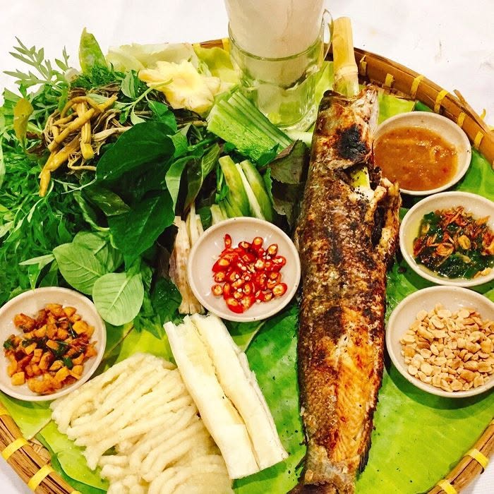 charcoal-grilled wild snakehead wrapped in fresh forest herbs