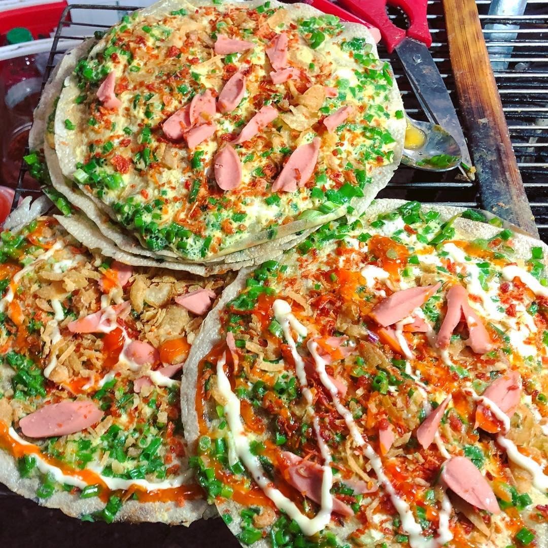 Grilled rice paper (often called Vietnamese pizza) topped with quail eggs, sautéed baby shrimp, scallion oil, and minced meat.